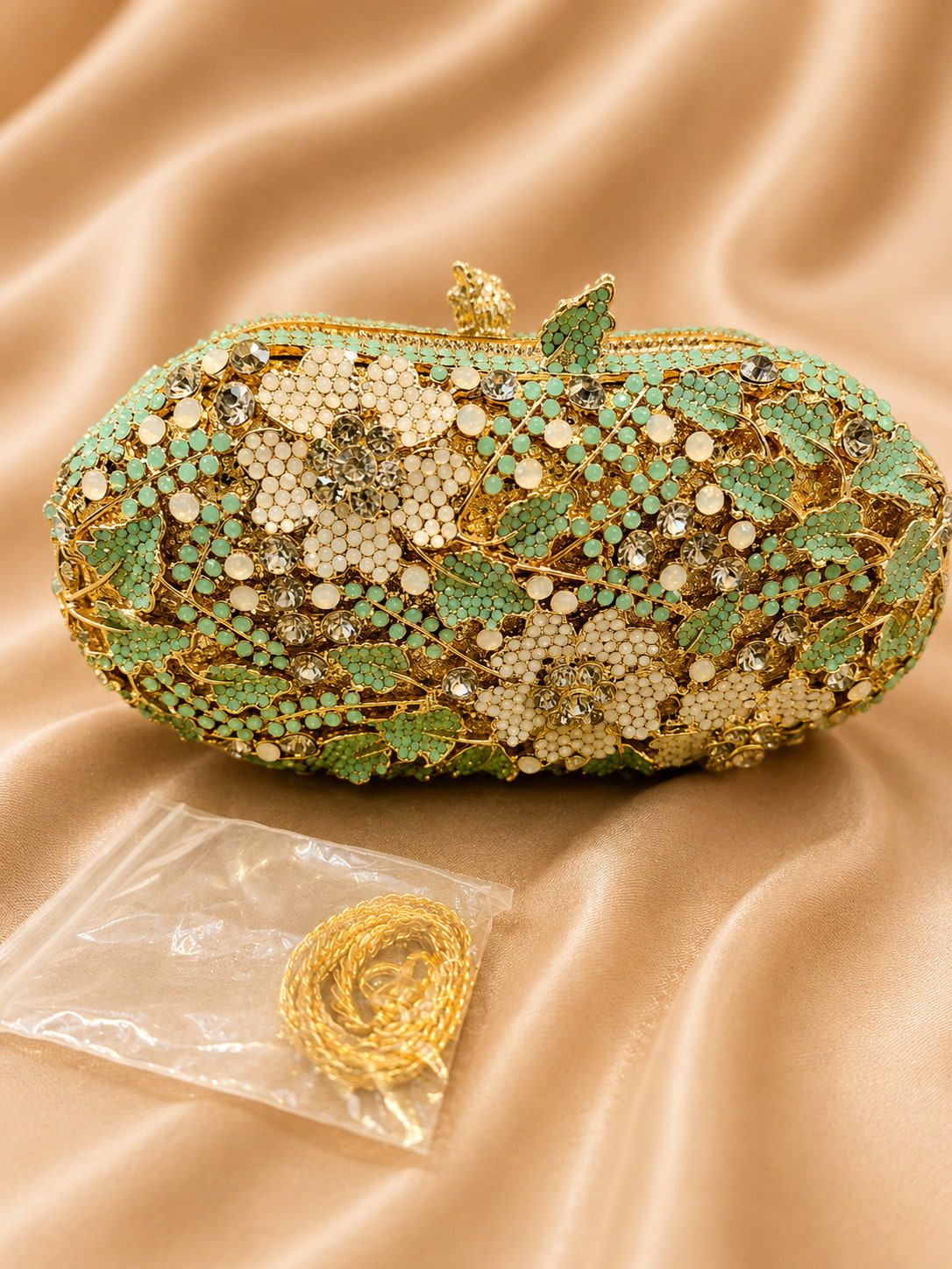 Decorative clutch bag with floral patterns on a beige fabric background